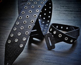 black/ textured leather guitar strap with silver grommets