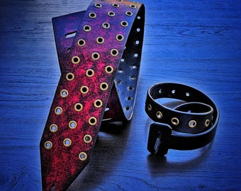 Red and black leather guitar strap with antique brass grommets