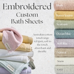 May include: Embroidered custom bath sheets in a range of colours, such as blush, butter lemon, and ocean blue. These towels are made from Australian cotton, soft, absorbent, and durable.
