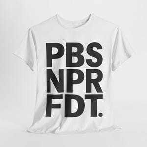 May include: White t-shirt with the black text "PBS NPR FDT." The shirt is made of a soft material and has short sleeves and a crew neck. The text is in a bold, sans-serif font.