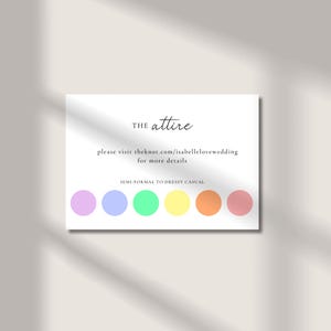 May include: A white card with the text "THE attire" in a handwritten font. Below, it reads "please visit theknot.com/isabellelovewedding for more details." A color palette of six pastel colors is at the bottom.