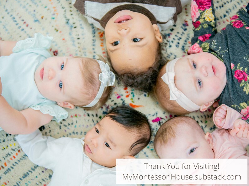 May include: Five babies lie on a patterned blanket, looking up at the camera.  The babies are of different ethnicities and have different hair colors.  The babies are wearing various outfits, including a white onesie, a pink onesie, a blue onesie, a white dress, and a black and white patterned dress.  The blanket is a light beige color with a multi-colored pattern.