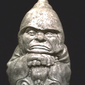 May include: A gray stone gnome statue with a pointed hat and a grumpy expression. The gnome is sitting with its hands clasped in front of it.