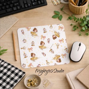 May include: White mouse mat featuring a repeating pattern of a girl in a yellow dress, pink bows, and decorative elements. The mouse mat has the text "Mighty90 Studio" in a script font.