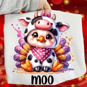May include: A whimsical illustration of a chick wearing a cow costume, complete with a pink bow, horns, and a polka-dot scarf. The chick has large, expressive eyes and is surrounded by colorful feathers. The word "moo" is printed at the bottom.