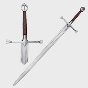 May include: A silver-colored steel sword featuring a long, tapered blade with a central fuller. The hilt includes a brown leather-wrapped grip, a circular pommel, and a crossguard with three-pronged, fork-like tips at each end of the quillons.