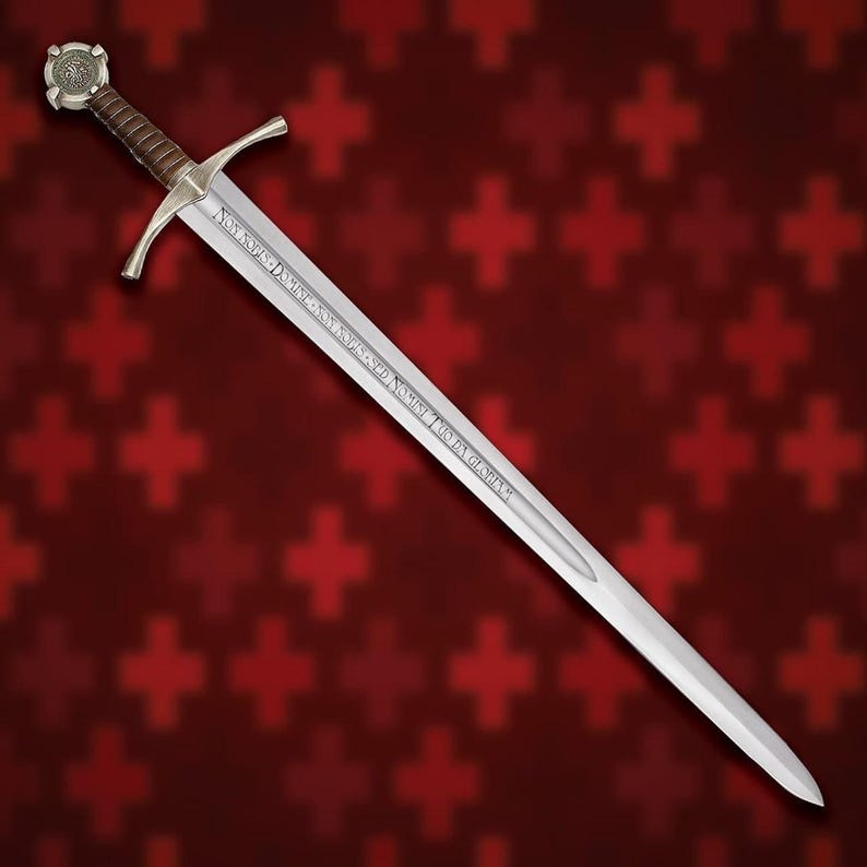 May include: A long, silver sword with a brown leather-wrapped handle and a cross-shaped guard. The blade has etched text. The pommel features a circular design. The background is a pattern of red crosses.