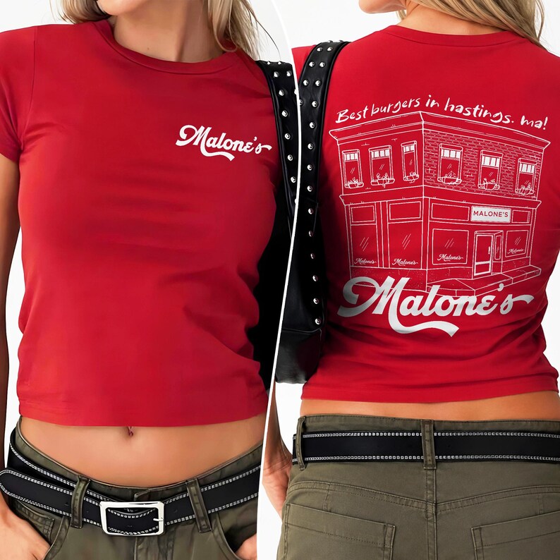 May include: A red short-sleeved t-shirt featuring the white text Malone's on the front. The back displays a white line drawing of a building with the text Best burgers in hastings, ma! and the word Malone's in a large script font below it.