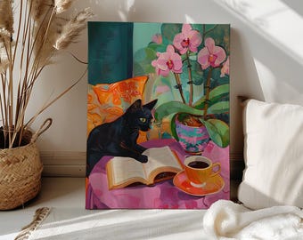 May include: A black cat sits on a pink surface with a book and a cup of coffee. The cat is looking at the book. There are pink orchids in a pot behind the cat.