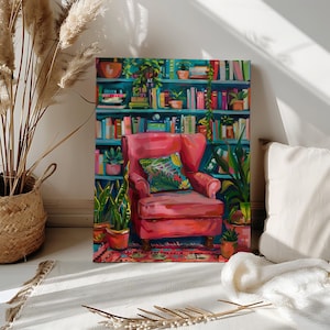 Puede incluir: Una pintura vibrante representa un rincón de lectura acogedor. Un sillón rosa con un cojín estampado se encuentra frente a una estantería turquesa llena de libros y plantas en macetas. La obra de arte está sobre una superficie blanca, con una cesta tejida y hierba de la pampa en el fondo.