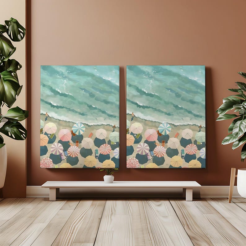 May include: Two canvas art pieces depicting a beach scene from a bird's-eye view. The top half shows turquoise waves, while the bottom half features colorful beach umbrellas. The artwork evokes a sense of summer and relaxation.