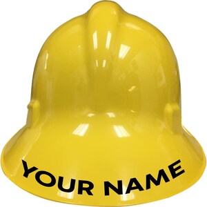May include: A yellow hard hat with a black brim and the text "YOUR NAME" printed on the brim.