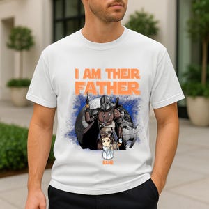 May include: White t-shirt with the text "I AM THEIR FATHER" in orange. The shirt features a graphic of a character in armor holding a weapon, with a child figure below. A blue and white background completes the design.