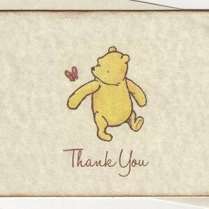 May include: A yellow cartoon bear with a red butterfly illustration. The bear is walking and looking at the butterfly. The text "Thank You" is written below the bear.