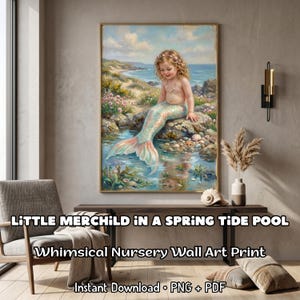 May include: A framed wall art print featuring a whimsical illustration of a young mermaid sitting on a rock in a spring tide pool. The artwork has a coastal background with a blue ocean and sky. The text on the print reads "LITTLE MERCHILD IN A SPRING TIDE POOL".