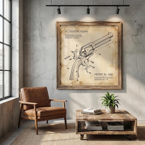 May include: A framed vintage print of a revolver firearm diagram, with the text "FIG. 1: REVOLVING FIREARM" and "PATENT No. 1858". The print is displayed in a room with a leather chair, wooden coffee table, and a potted plant.