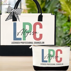 May include: A white tote bag and matching cosmetic bag with black accents. Both bags display the letters "LPC" in blue, green, and red, the name "Alyssa", and the text "LICENSED PROFESSIONAL COUNSELOR". A black and white striped bow adorns the tote bag.