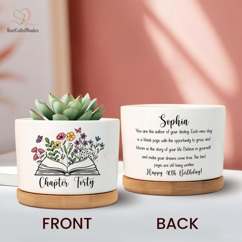 May include: White ceramic planter with a succulent plant, featuring a floral and butterfly design with the text "Chapter Forty." The back of the planter has the name "Sophia" and a birthday message. The planter sits on a wooden base.