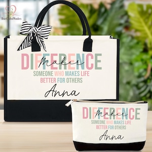 May include: A white tote bag and matching cosmetic bag with the text "DIFFERENCE" and "SOMEONE WHO MAKES LIFE BETTER FOR OTHERS" printed on them. The tote bag has black handles and a black base, and a black and white striped bow. The cosmetic bag has a black base and a zipper.