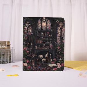 May include: A rectangular notebook featuring a dark, gothic-inspired illustration of a library interior with bookshelves, lit candles, skulls, and climbing roses. The scene includes arched windows, glass vials, and an open book on the floor.