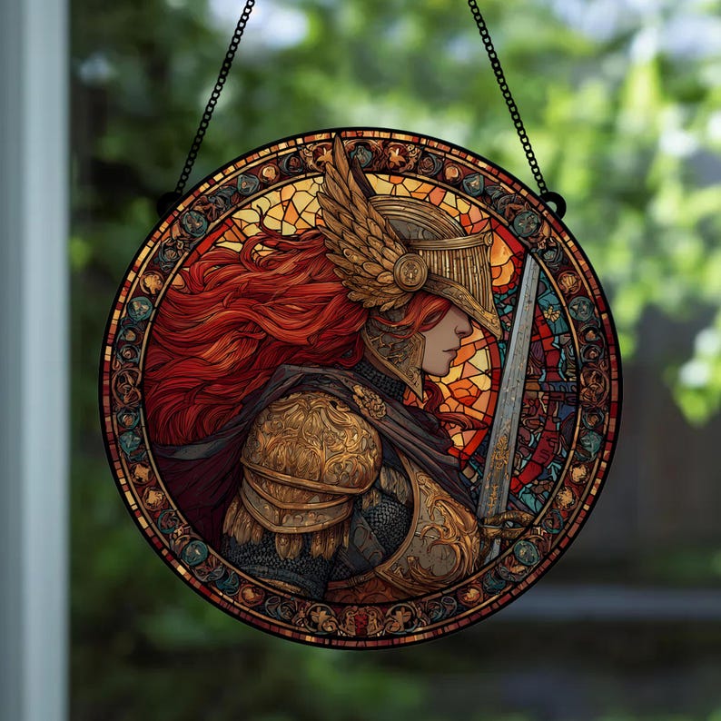 May include: Round stained glass window art featuring a warrior in golden armor, a winged helmet, and flowing red hair, holding a sword. The artwork has a detailed, mosaic-like design with a black chain for hanging.