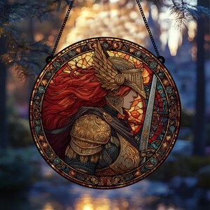 May include: Round stained glass window featuring a warrior with red hair, wearing a golden helmet and armor, holding a sword. The artwork is set against a backdrop of colorful stained glass and a blurred outdoor scene, with a black chain for hanging.