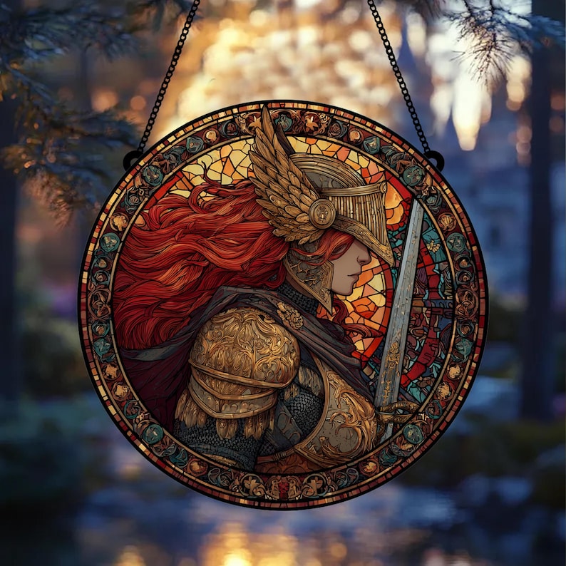 May include: Round stained glass window featuring a warrior with red hair, wearing a golden helmet and armor, holding a sword. The artwork is set against a backdrop of colorful stained glass and a blurred outdoor scene, with a black chain for hanging.