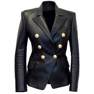 May include: A black leather blazer with a double-breasted design. The blazer features six gold-colored buttons and two front pockets. The jacket has a tailored fit and a classic lapel.