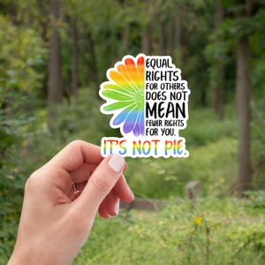 May include: A sticker with a rainbow daisy and the text "EQUAL RIGHTS FOR OTHERS DOES NOT MEAN FEWER RIGHTS FOR YOU. IT'S NOT PIE."
