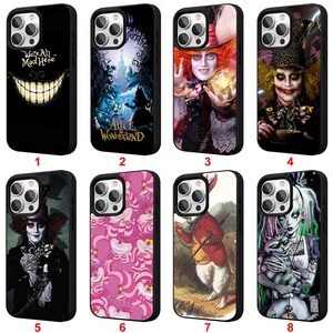 May include: Collection of eight black phone cases with various designs from Alice in Wonderland. Designs include the Cheshire Cat, Mad Hatter, and other characters. Each case is designed to fit a smartphone.