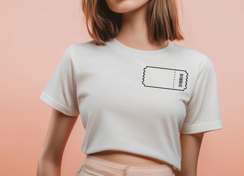 May include: White t-shirt featuring a black ticket graphic on the chest. The ticket design includes a barcode and a perforated edge. The shirt has short sleeves and a crew neck, suitable for casual wear.