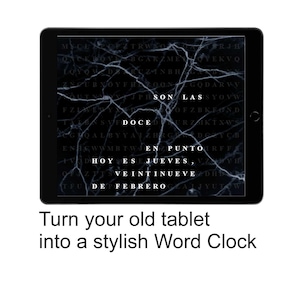 May include: A black tablet displays a word clock with white text on a dark background. The text reads "SON LAS DOCE EN PUNTO, HOY ES JUEVES, VEINTINUEVE DE FEBRERO." The tablet is framed by a black bezel. The text "Turn your old tablet into a stylish Word Clock" is below.