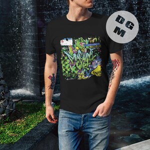 May include: A black t-shirt with a colorful graphic print of a cartoon character and the text "MACHINE GIRL".