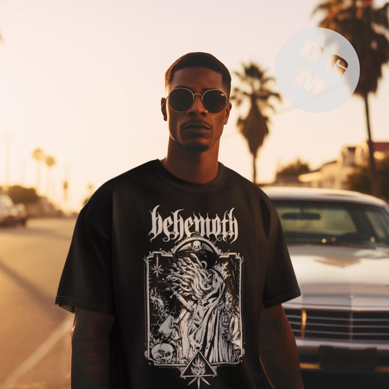 May include: Black t-shirt with a white graphic print of a skull with horns and the word "Behemoth" above it.