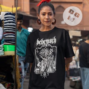 May include: Black t-shirt with a white graphic print of a skull with tentacles and the word "Behemoth" above it.