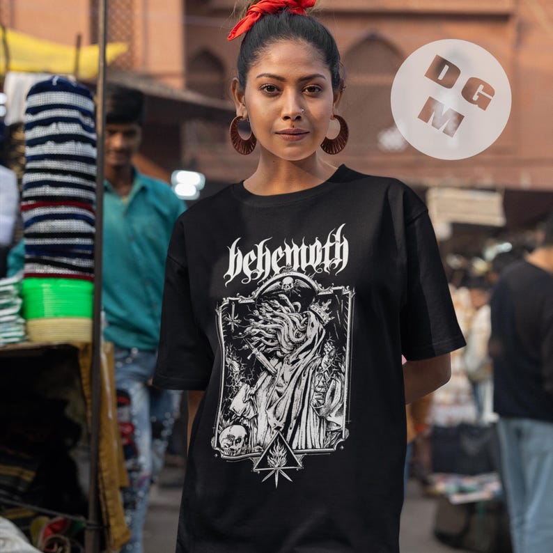 May include: Black t-shirt with a white graphic print of a skull with tentacles and the word "Behemoth" above it.