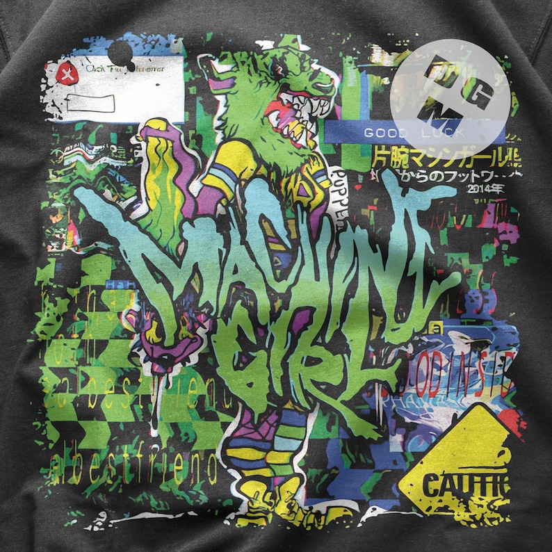 May include: A black sweatshirt with a colorful graphic print of a cartoon monster with the text "MACHINE GIRL" and "GOOD LUCK 片腕マシンガールル からのフットワ・・ 2014年" in Japanese.