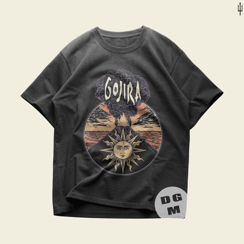 May include: A dark gray t-shirt with a graphic print of a volcano erupting with a sun and the word "GOJIRA" above it.