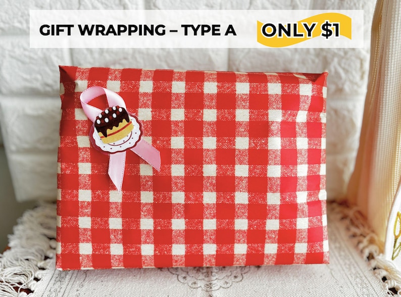 May include: A gift wrapped in red and white checkered paper, adorned with a pink ribbon and a decorative cake-shaped embellishment. The text "GIFT WRAPPING - TYPE A" is visible at the top.