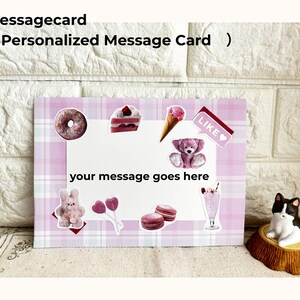 May include: A personalized message card with a pink plaid design, adorned with stickers of a donut, cake, ice cream cone, teddy bear, bunny, macarons, and a milkshake. The card reads "your message goes here".