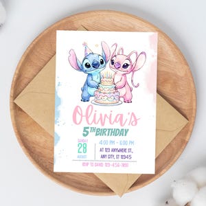 May include: A birthday invitation with a blue and pink cartoon character holding a cake. The invitation text reads "Olivia's 5th Birthday" with event details, including date, time, and location. The invitation is on a white background, presented on a wooden tray.