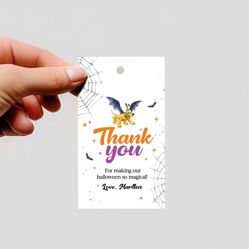 May include: A white Halloween-themed gift tag with a cartoon dog wearing bat wings, the words "Thank you" in orange and purple, and spiderwebs. The tag also includes the text "For making our halloween so magical!" and "Love, Marllen."
