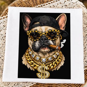 May include: A white square fabric item featuring a graphic print of a French Bulldog wearing a black baseball cap, leopard print sunglasses, and multiple thick gold chains with a large dollar sign pendant, while holding a lit cigar in its mouth.