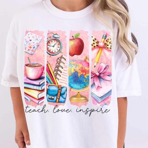 May include: White t-shirt with a pink and white design featuring school supplies, a globe, an apple, and a pencil. The text "teach. love. inspire" is printed below the design.