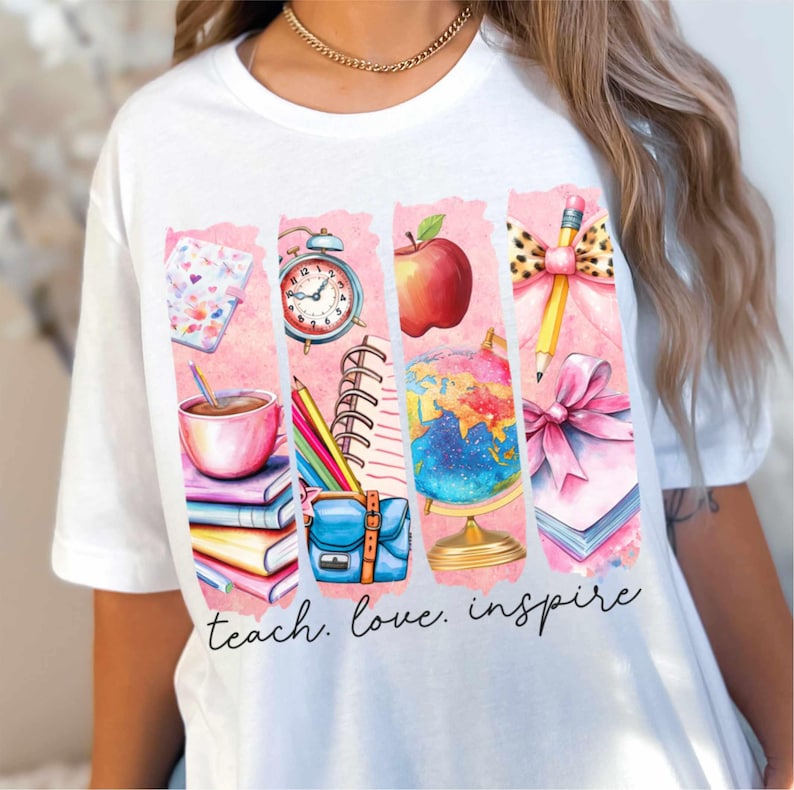 May include: White t-shirt with a pink and white graphic design featuring school supplies, a globe, an apple, and a clock. The text "teach. love. inspire" is printed below the graphic.