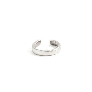 May include: A silver ear cuff with a smooth, rounded surface.