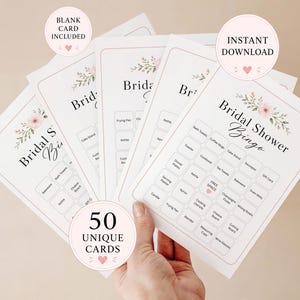 May include: A set of white Bridal Shower Bingo cards featuring a floral header with pink flowers and green leaves. Each card contains a grid of kitchen and household items, a free space, and the text Bridal Shower Bingo. Includes 50 unique cards.