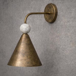 May include: A white ceramic mug with a black handle and the text "But First, Coffee" in a black, bold font. The mug is on a white surface.