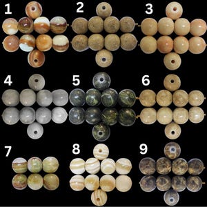 May include: Nine sets of gemstone beads in various colors and patterns. The beads are round with a hole drilled through the center. Colors include cream, brown, green, and gray. Some beads have a marbled or striped appearance.