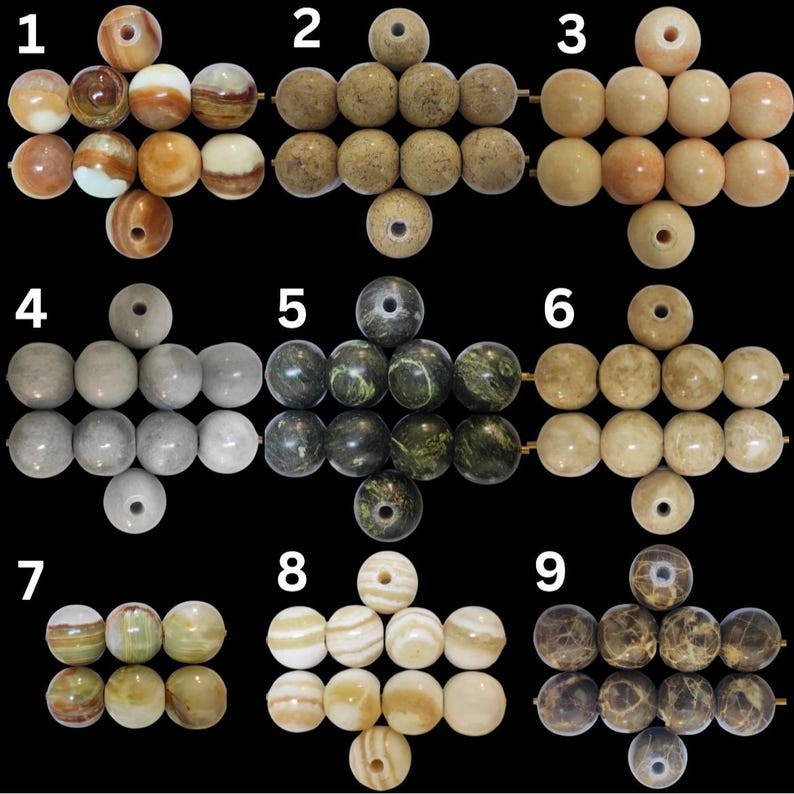 May include: Nine sets of gemstone beads in various colors and patterns. The beads are round with a hole drilled through the center. Colors include cream, brown, green, and gray. Some beads have a marbled or striped appearance.